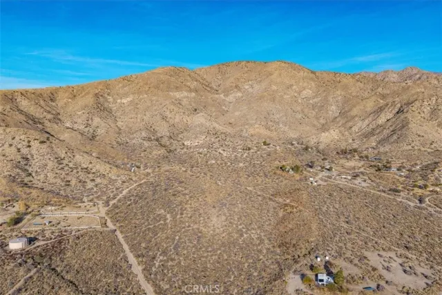 a view of a large mountain with trees in the background