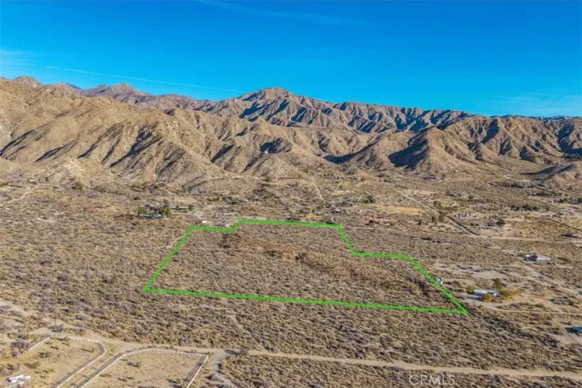 a view of a large mountain with a mountain in the background