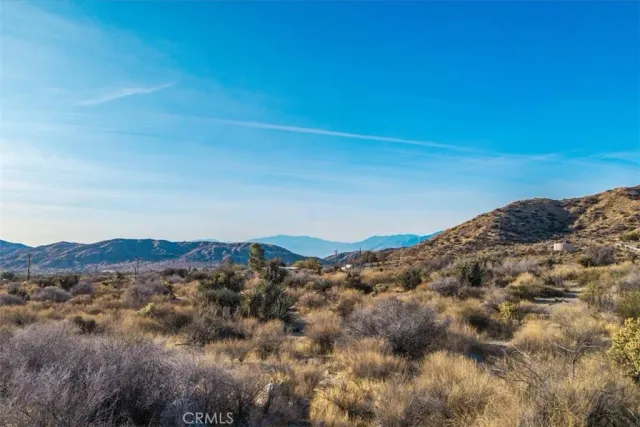 a view of a large building with mountains in the background