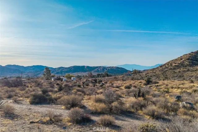 a view of a mountain range in a cloudy sky