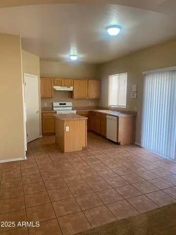 a kitchen with stainless steel appliances granite countertop a sink and cabinets