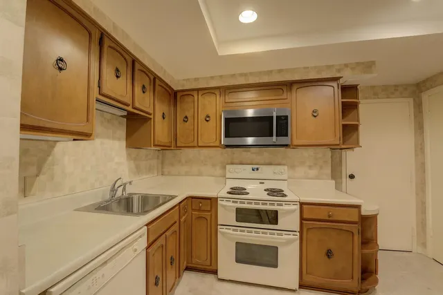 a bathroom with a shower sink and mirror