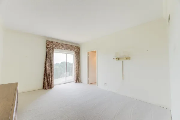 a spacious bedroom with a bed and couch