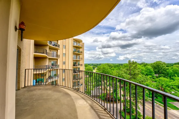 a view of a balcony with a yard
