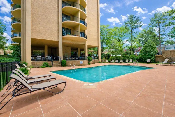 a living room with patio furniture and a floor to ceiling window