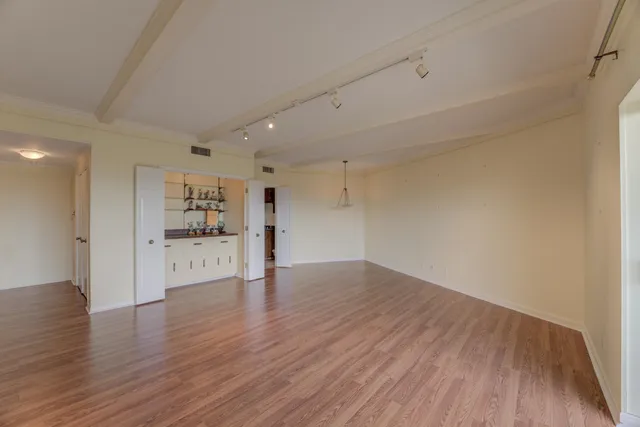 a view of a kitchen with wooden floor