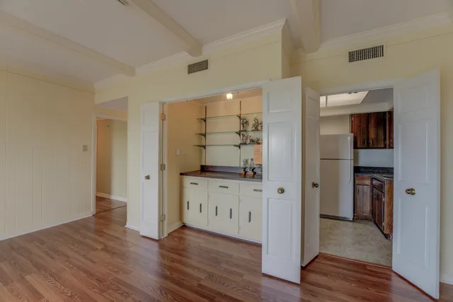 a view of a utility room with cabinet and a window