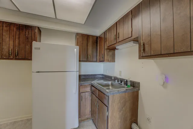 a bathroom with a double vanity sink toilet and a tub
