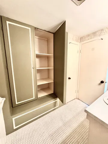 a bathroom with a glass shower door and a window