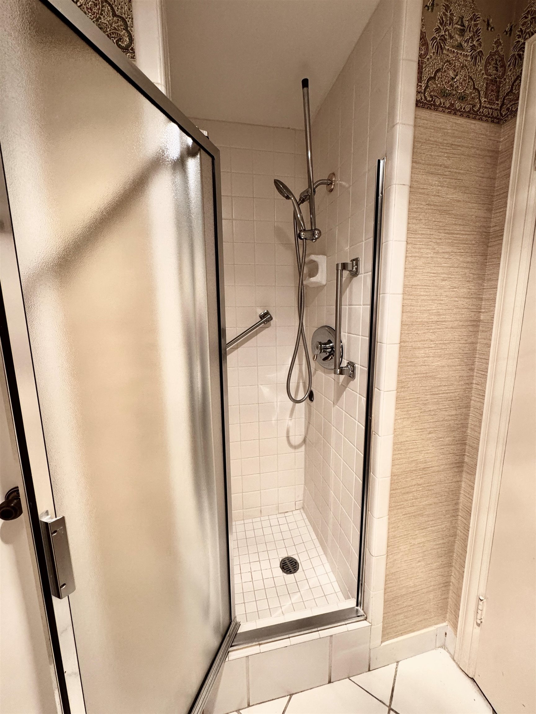 475 North Highland Street, Unit 9AB Memphis, TN 38122 - Photo 29 of 40 a bathroom with a glass shower door and a window