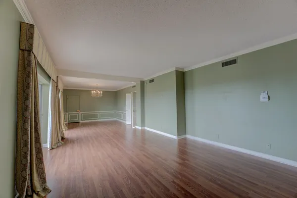 a view of a room with wooden floor and window