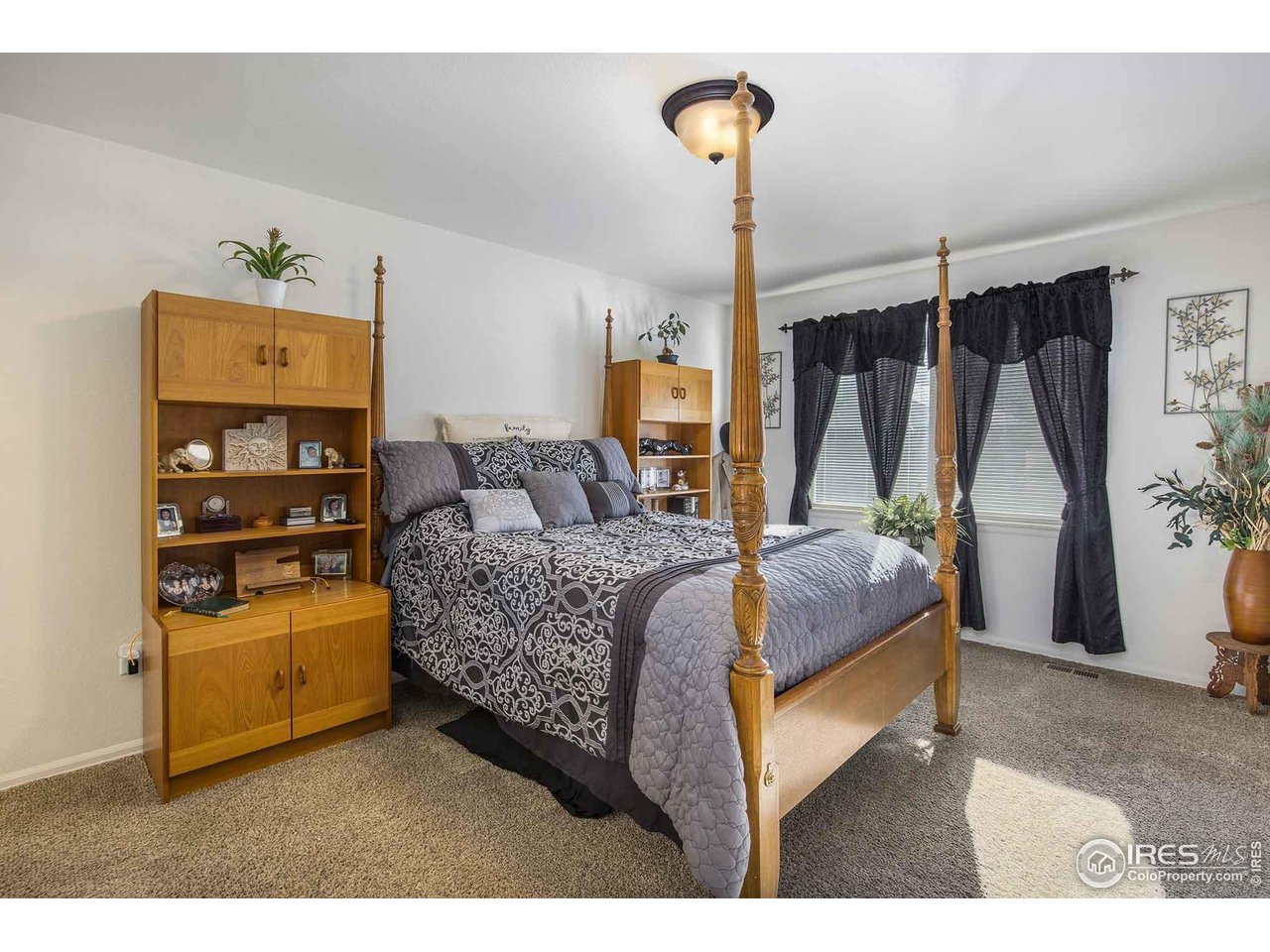 1329 85th Avenue Greeley, CO 80634 - Photo 11 of 22 a bedroom with a bed and a table