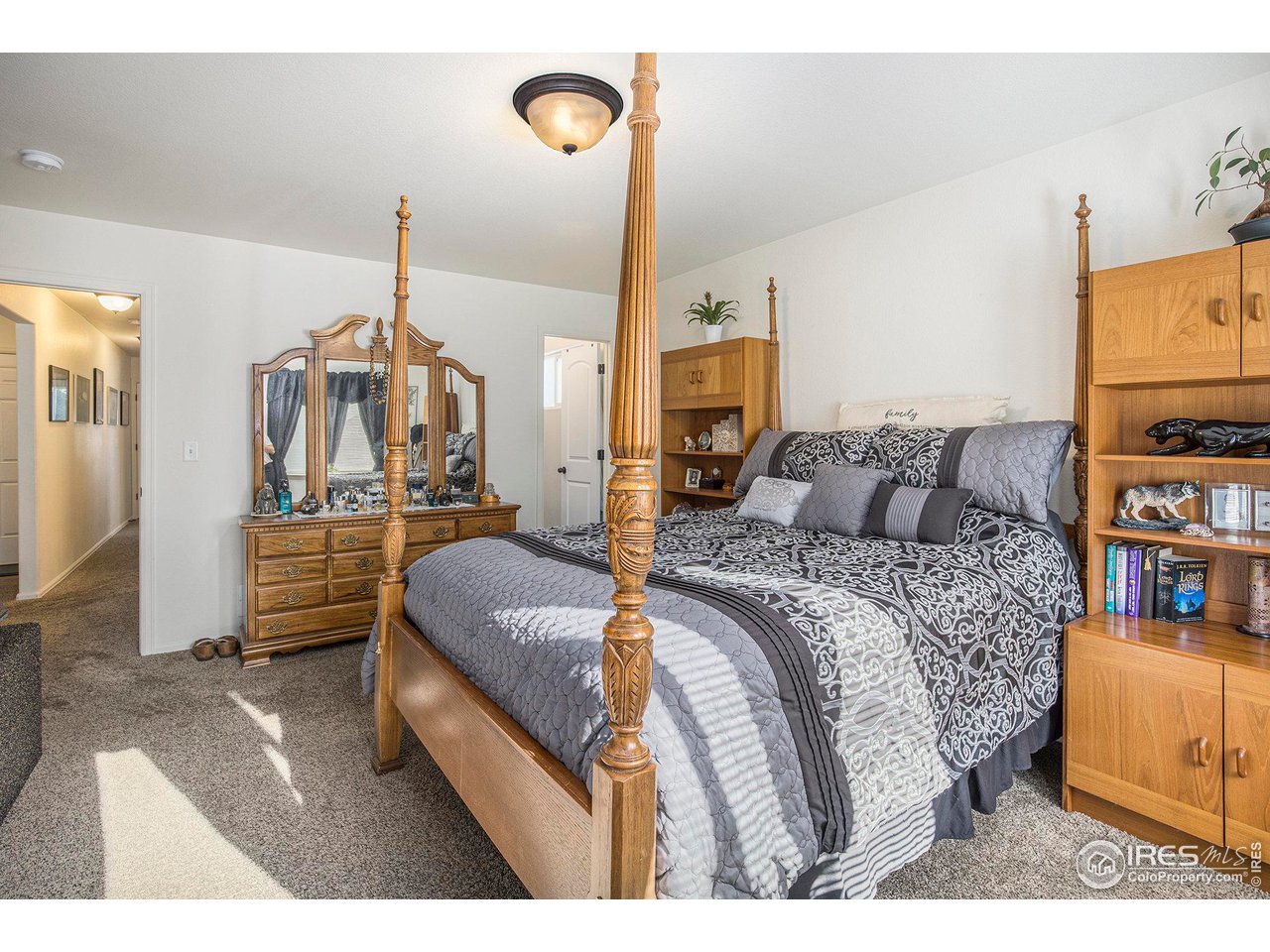 1329 85th Avenue Greeley, CO 80634 - Photo 12 of 22 a bedroom with a bed a couch and dresser