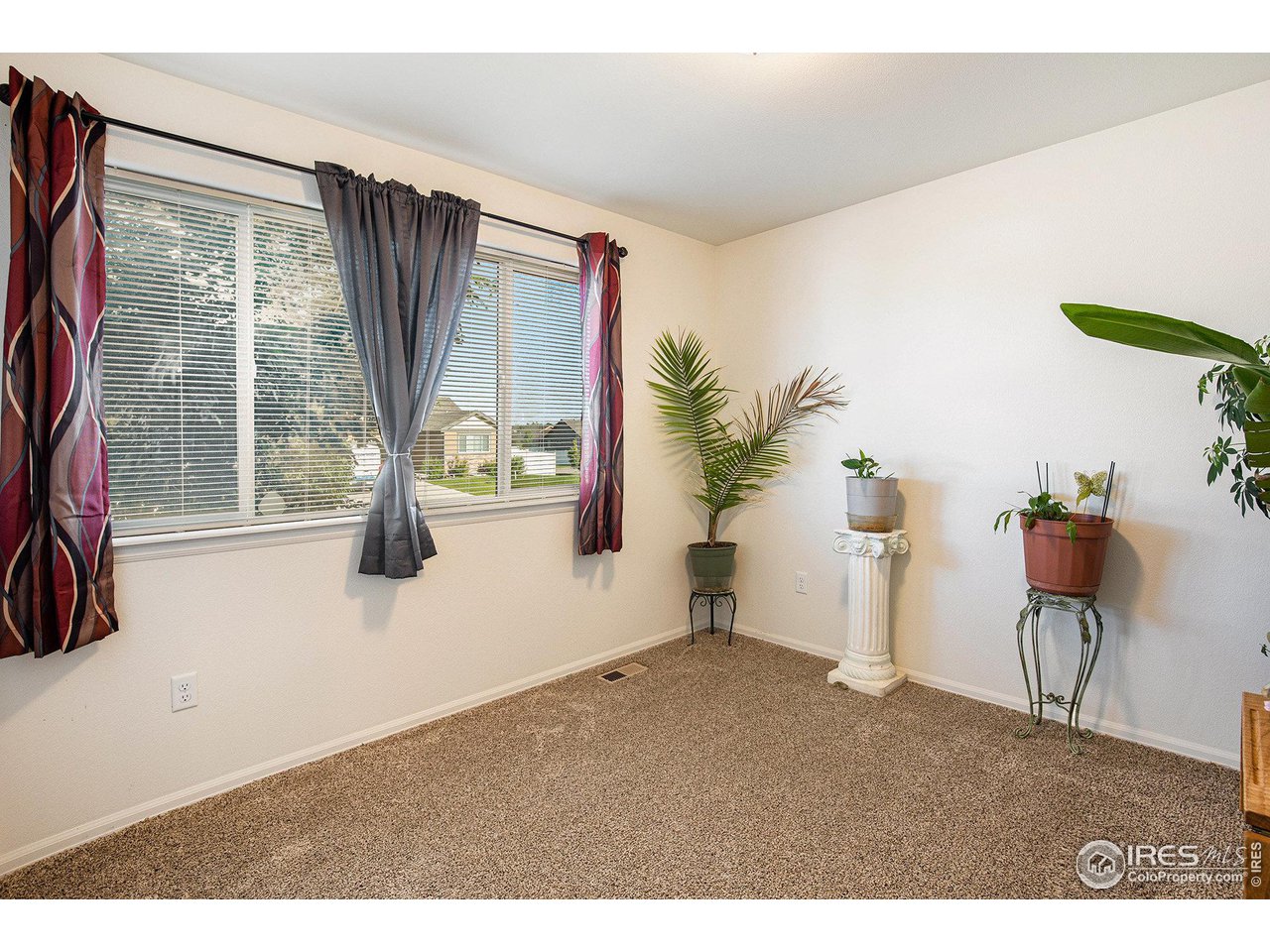 1329 85th Avenue Greeley, CO 80634 - Photo 14 of 22 a view of livingroom with furniture and floor to ceiling window