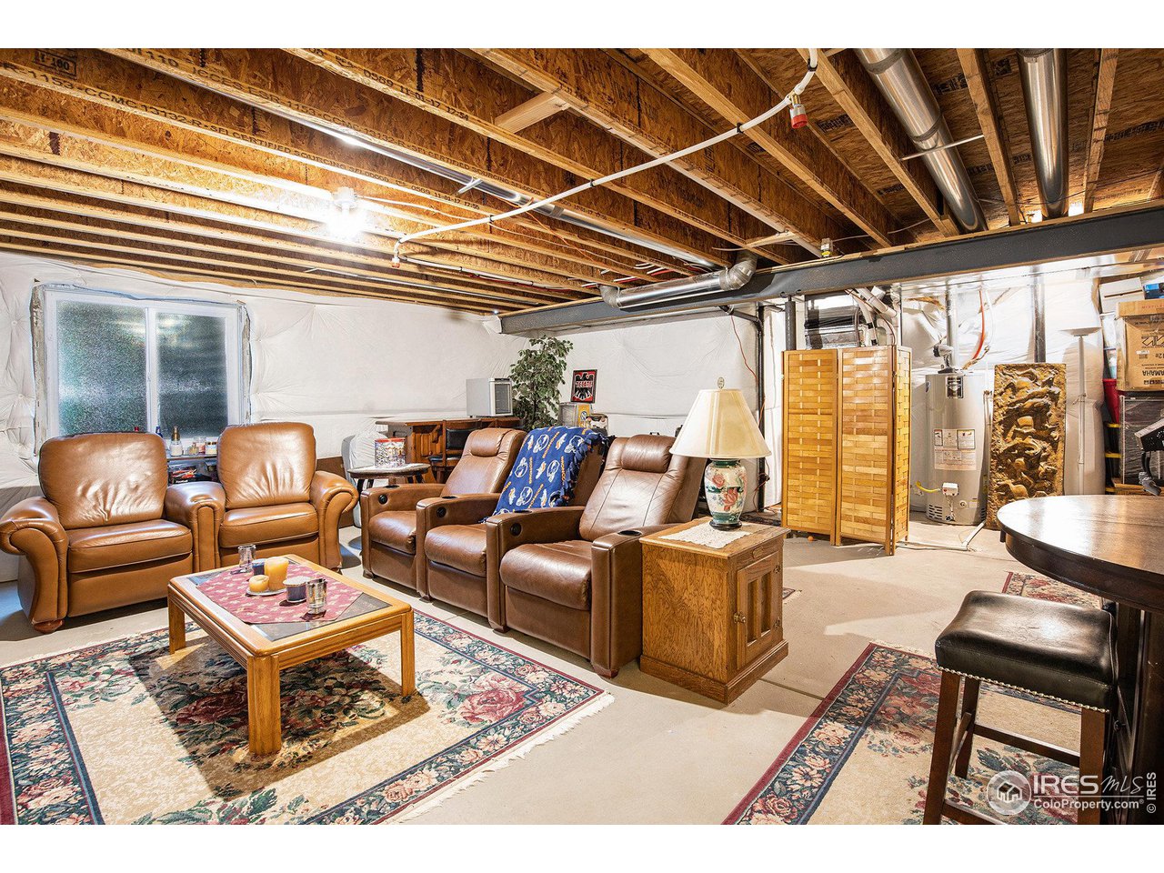 1329 85th Avenue Greeley, CO 80634 - Photo 19 of 22 a living room with furniture a flat screen tv and a table