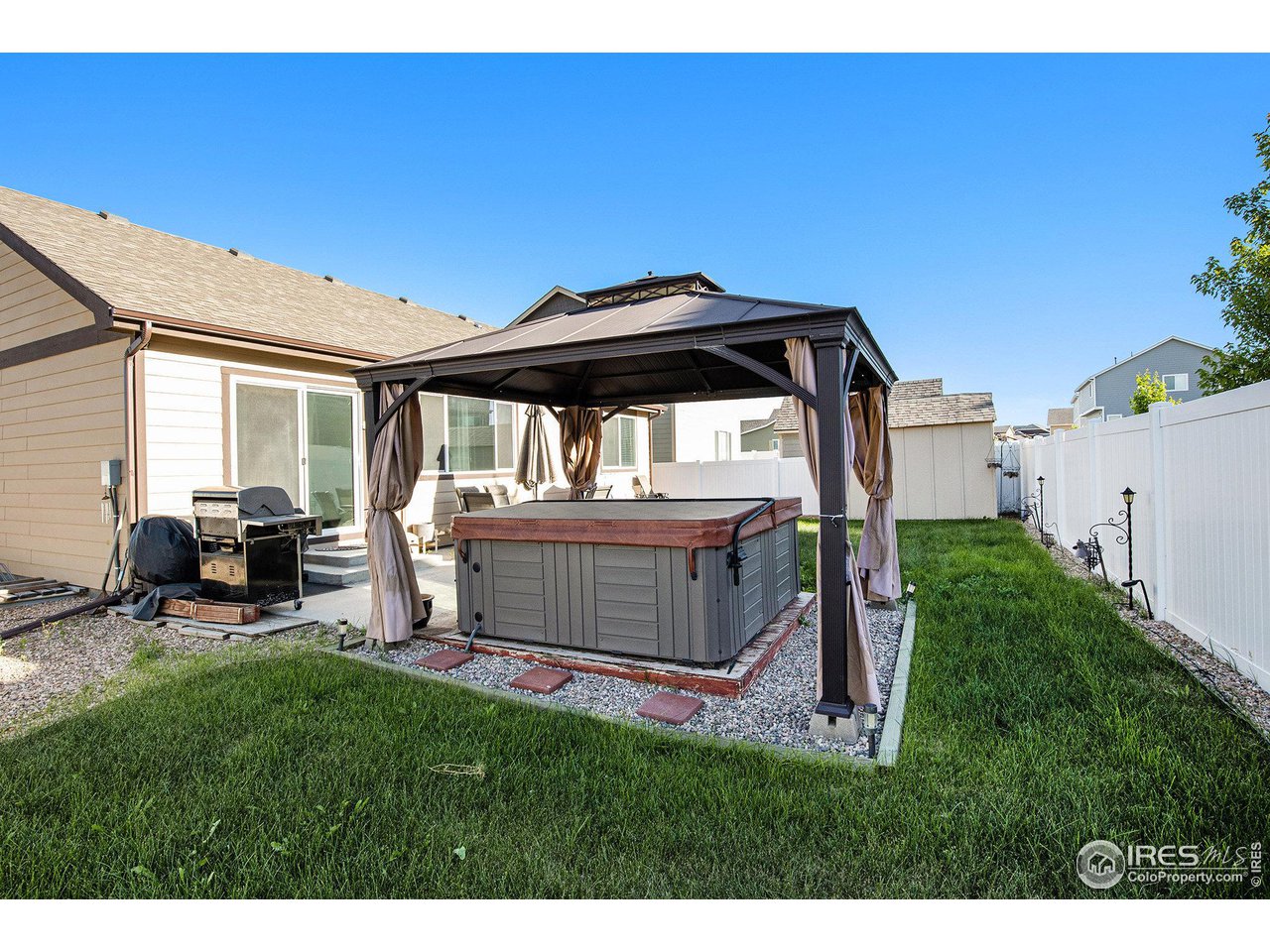 1329 85th Avenue Greeley, CO 80634 - Photo 22 of 22 a front view of a house with a garden and chairs