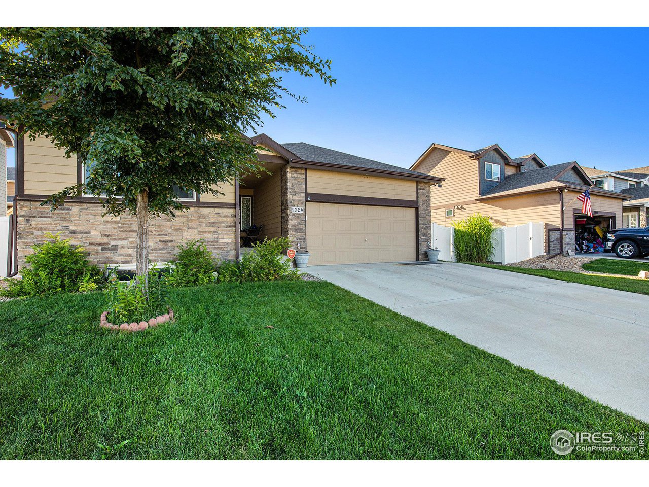 1329 85th Avenue Greeley, CO 80634 - Photo 4 of 22 a front view of a house with a yard and garage