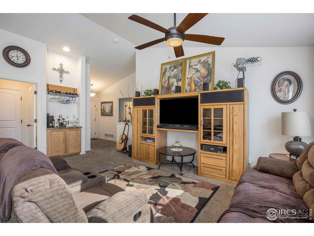 1329 85th Avenue Greeley, CO 80634 - Photo 5 of 22 a living room with furniture and a flat screen tv