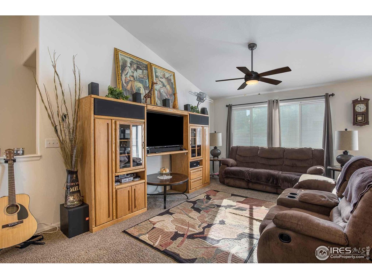 1329 85th Avenue Greeley, CO 80634 - Photo 6 of 22 a living room with furniture and a flat screen tv