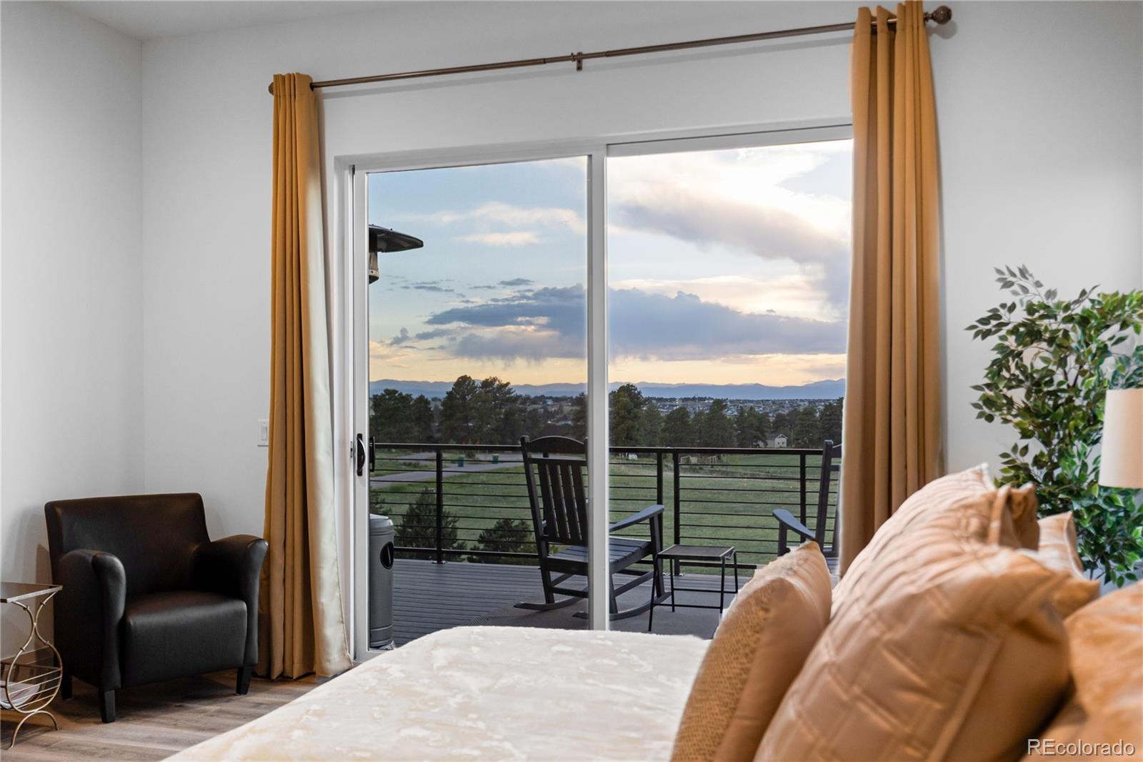 10689 Shadow Pines Road Parker, CO 80138 - Photo 24 of 50 a bedroom with a bed and glass window