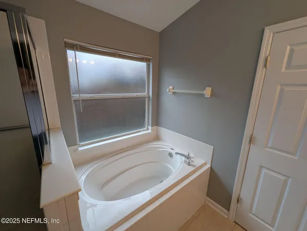 a bathroom with a tub and a sink