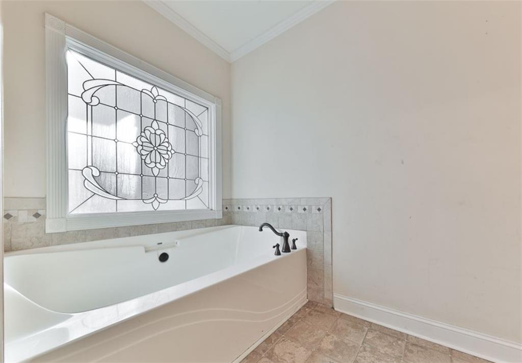 1523 Braswell Mountain Road Dallas, GA 30132 - Photo 17 of 34 a bathroom with a bathtub and next to a window