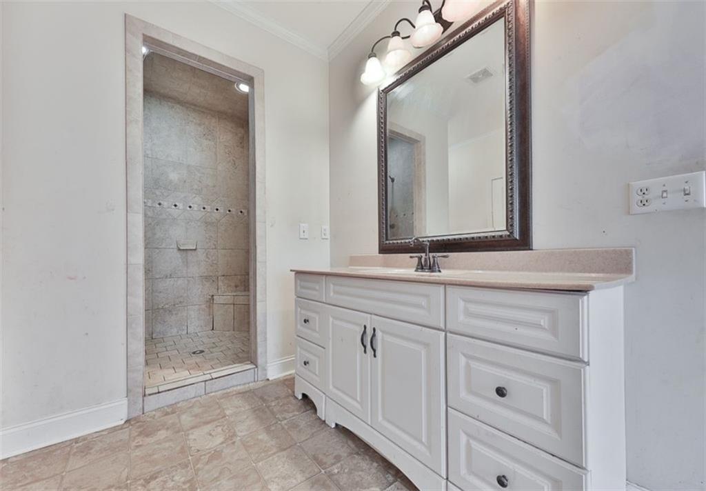1523 Braswell Mountain Road Dallas, GA 30132 - Photo 18 of 34 a bathroom with a shower sink and mirror