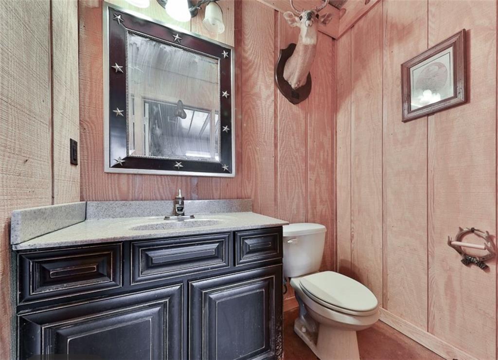 1523 Braswell Mountain Road Dallas, GA 30132 - Photo 21 of 34 a bathroom with a toilet a sink and mirror