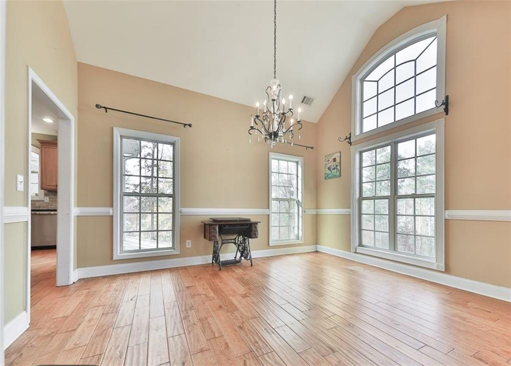 1523 Braswell Mountain Road Dallas, GA 30132 - Photo 6 of 34 an empty room with wooden floor fan and windows