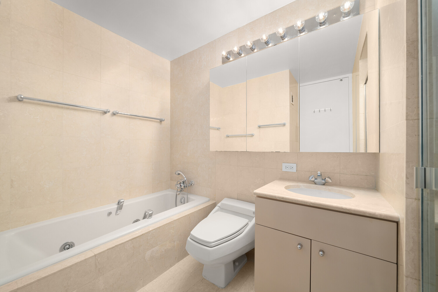 160 West 66th Street, Unit 31D Manhattan, NY 10023 - Photo 7 of 10 a bathroom with a sink a toilet and shower