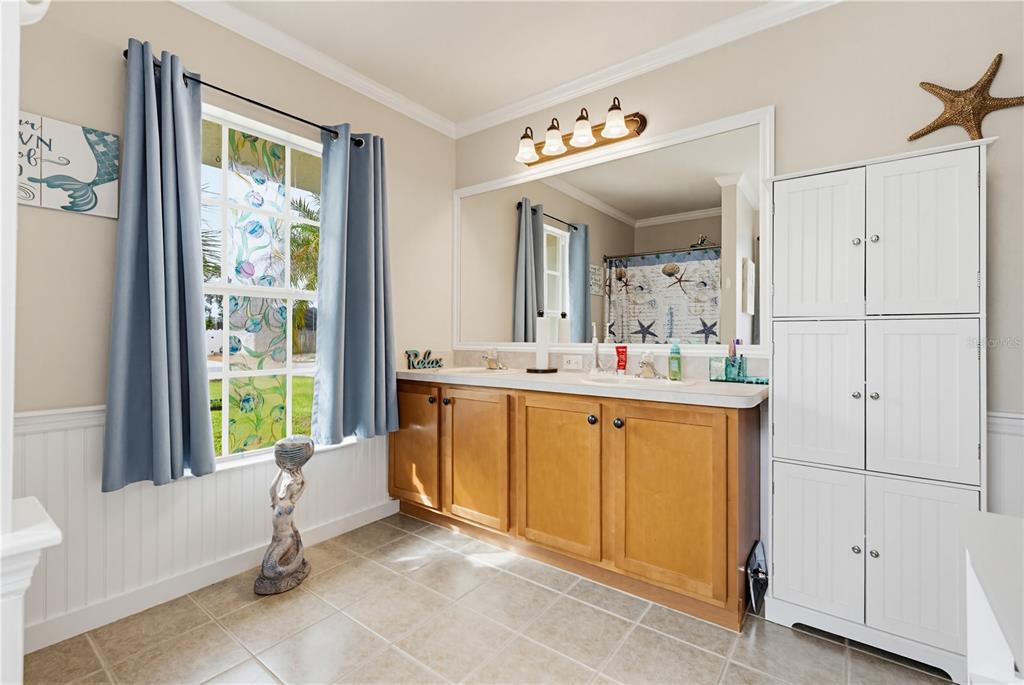 3497 Chadwick Avenue Spring Hill, FL 34609 - Photo 27 of 47 a bathroom with a sink a mirror and a bathtub