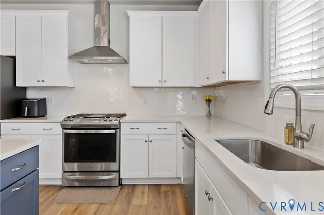 a kitchen with stainless steel appliances kitchen island granite countertop a sink a stove a dining table and chairs