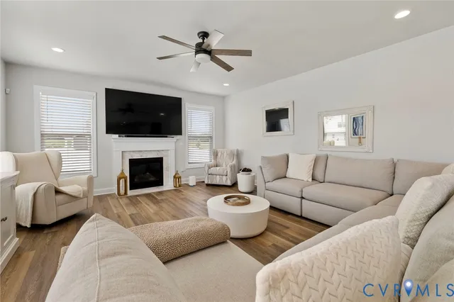 a living room with furniture a flat screen tv and a fireplace