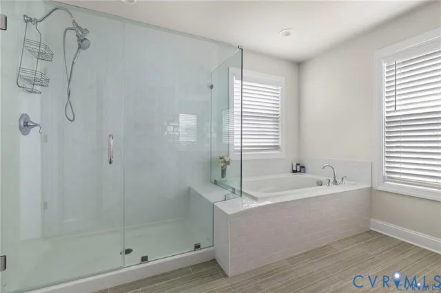 a white bath tub sitting next to a shower