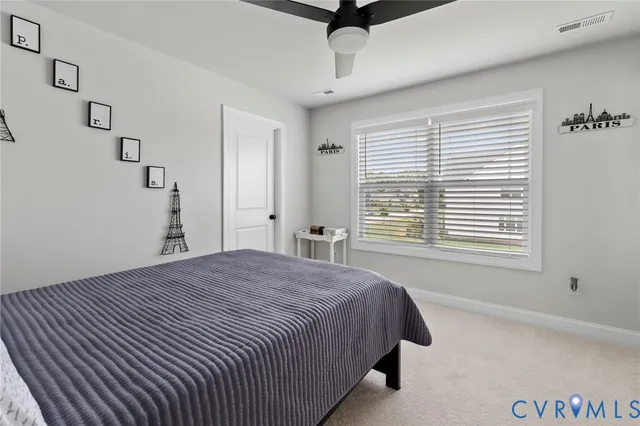a bathroom with a sink a toilet and shower curtain