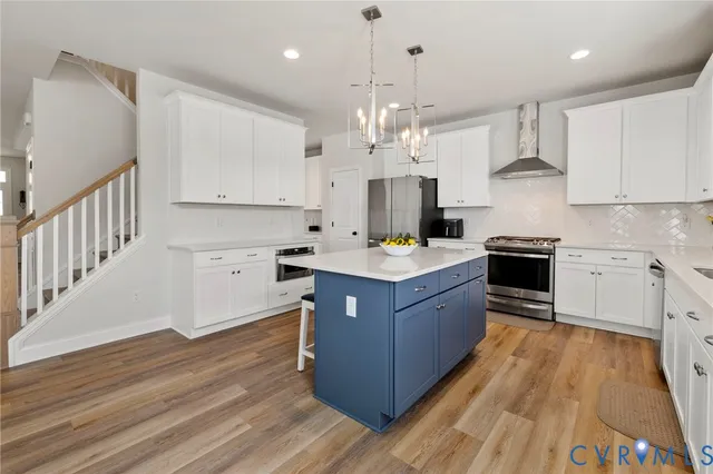 a kitchen with stainless steel appliances a refrigerator sink and cabinets
