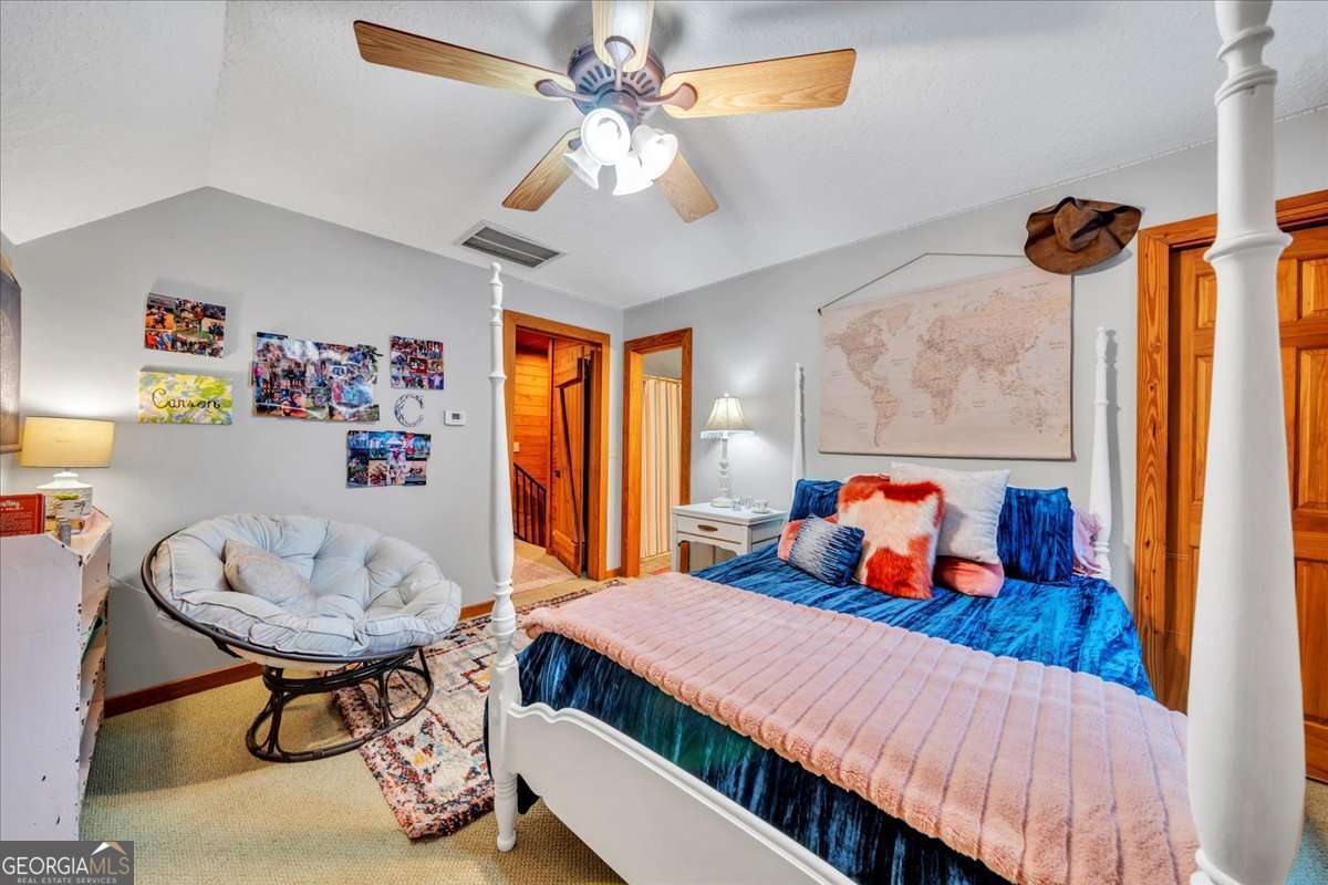 568 Hopewell Church Road Rhine, GA 31077 - Photo 27 of 79 a bedroom with a bed and dresser with mirror