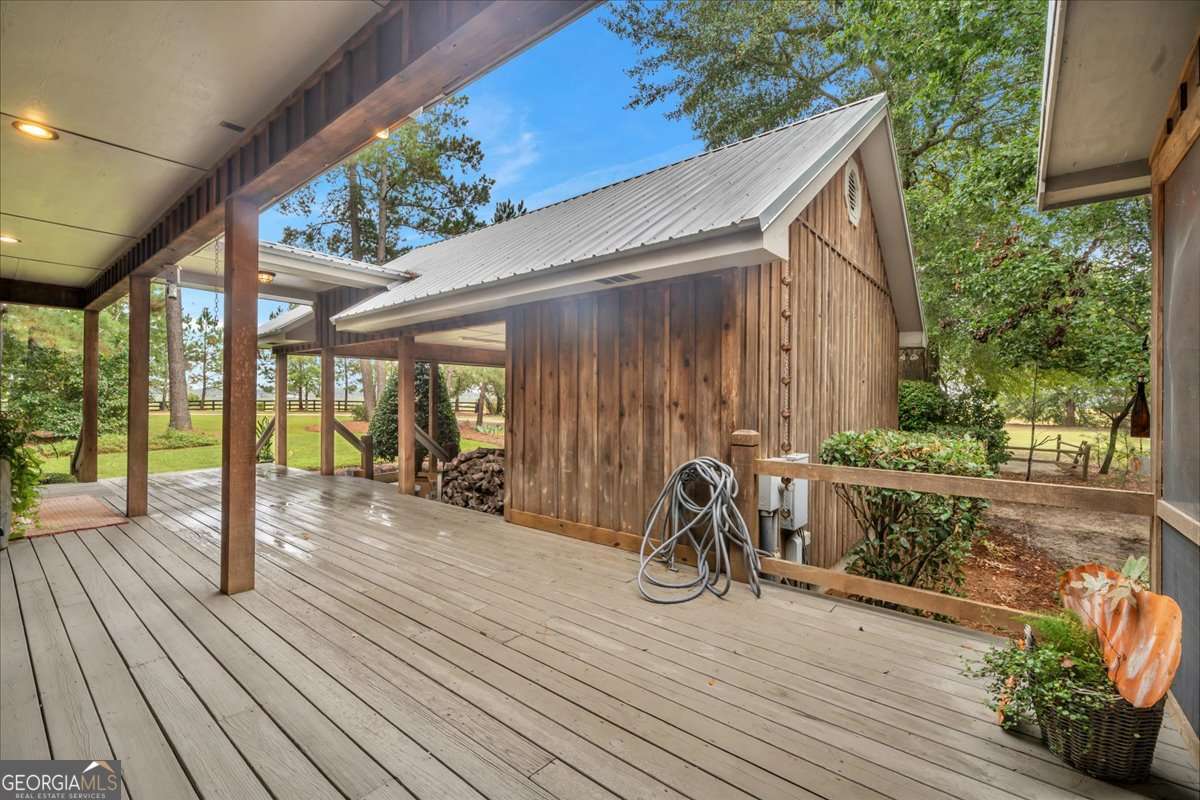 568 Hopewell Church Road Rhine, GA 31077 - Photo 44 of 79 a view of a deck with wooden floor and roof with a garden view
