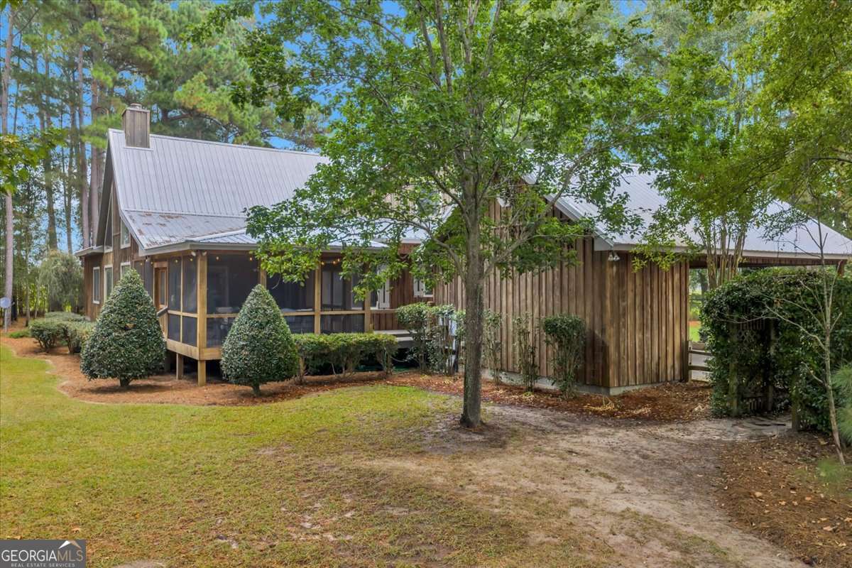 568 Hopewell Church Road Rhine, GA 31077 - Photo 68 of 79 a backyard of a house with plants and tree