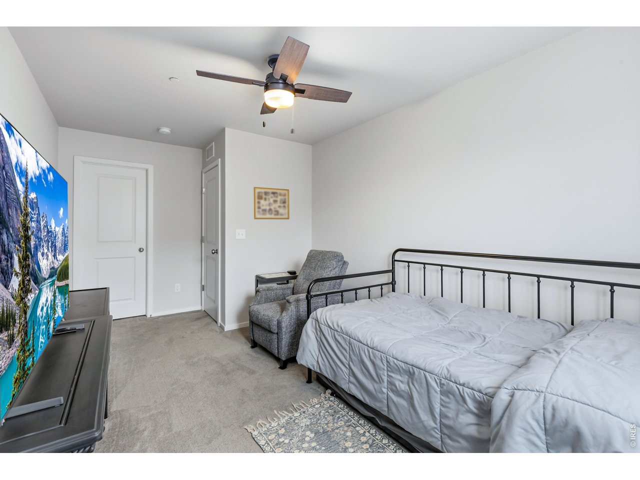 6609 4th St Road, Unit 4 Greeley, CO 80634 - Photo 30 of 41 a bed room with a bed and a chandelier
