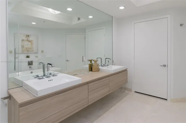 a bathroom with a sink vanity and a mirror