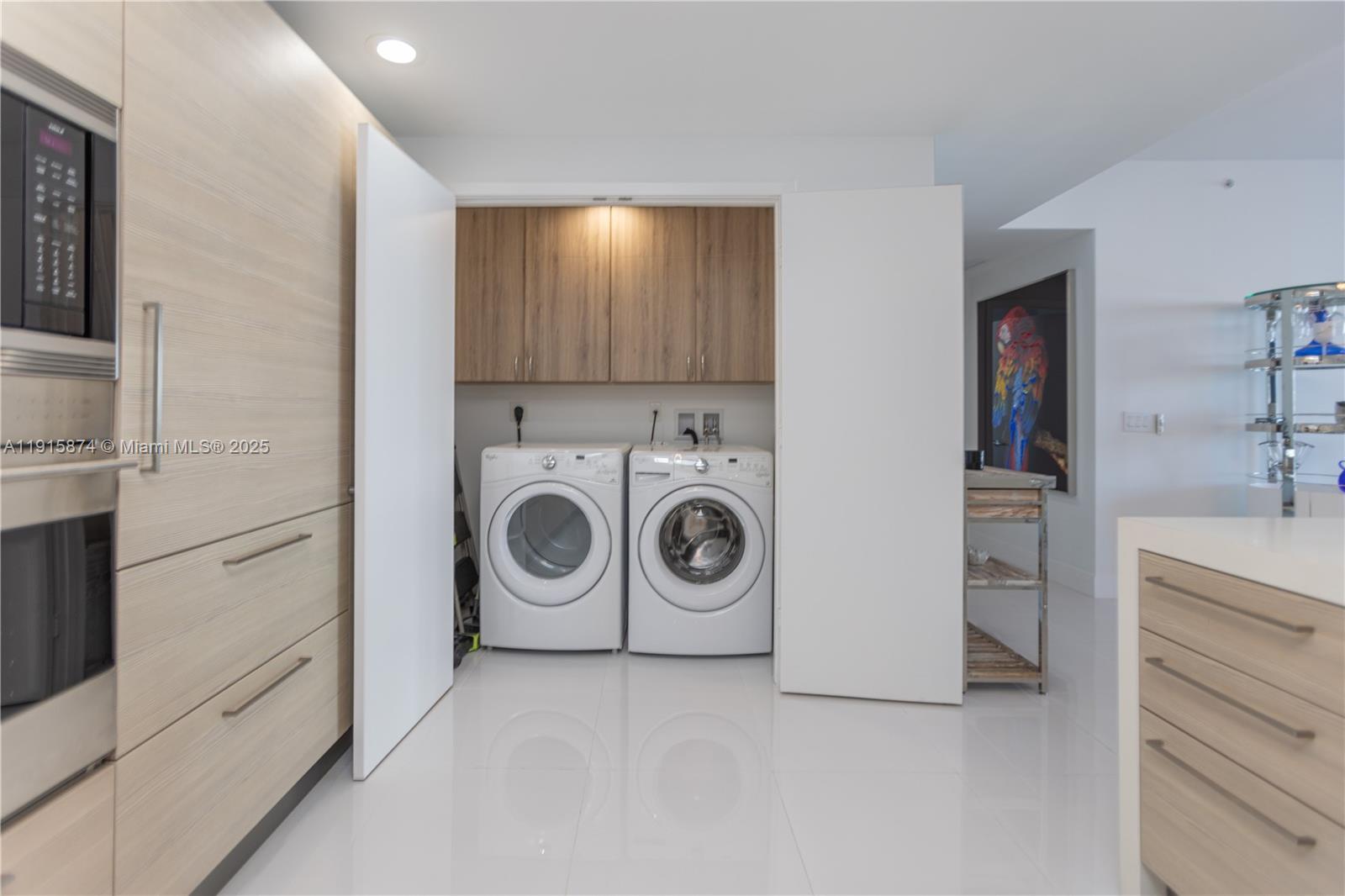 17111 Biscayne Boulevard, Unit 505 North Miami Beach, FL 33160 - Photo 28 of 29 a utility room with sink dryer and washer