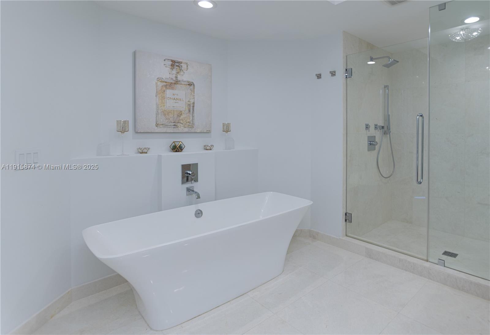 17111 Biscayne Boulevard, Unit 505 North Miami Beach, FL 33160 - Photo 9 of 29 a white bath tub sitting next to a shower