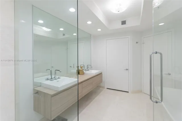 a bathroom with a double vanity sink mirror and double