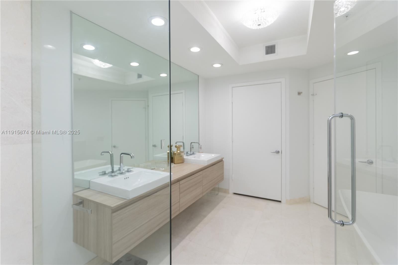 17111 Biscayne Boulevard, Unit 505 North Miami Beach, FL 33160 - Photo 10 of 29 a bathroom with a double vanity sink mirror and double