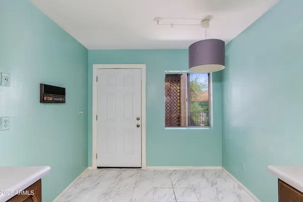 a view of a hallway with wooden floor and glass door