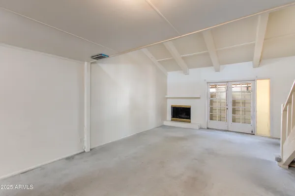 a view of staircase with white walls and a window