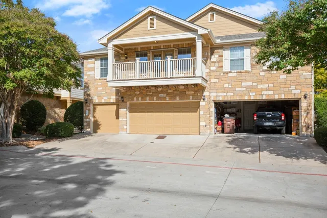 a front view of a house with a yard and a garage