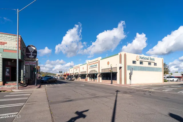 a view of a brick wall with a city street