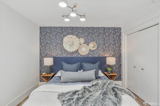 a bed room with a bed mirror and a window